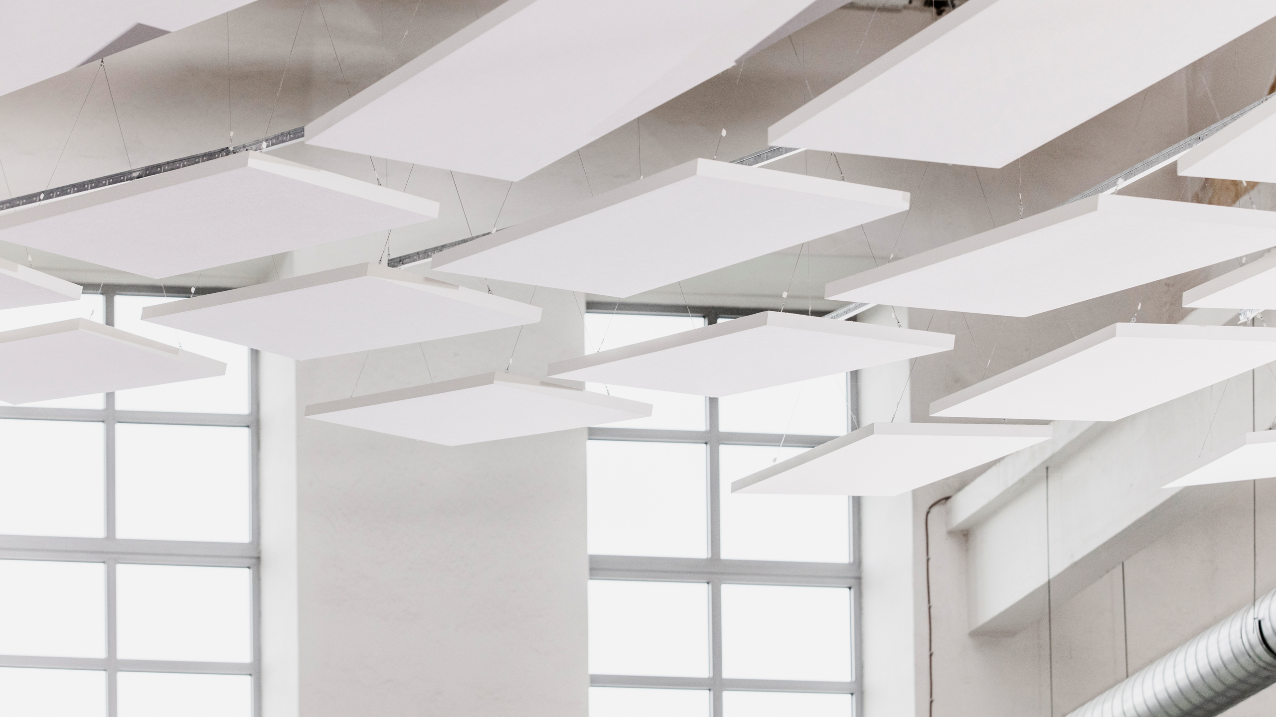 Free-hanging acoustic panels in industrial building