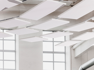 Free-hanging acoustic panels in industrial building