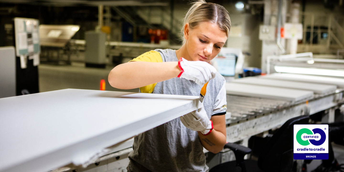 Female Ecophon co-worker inspecting an acoustic panel at the production line