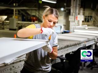 Female Ecophon co-worker inspecting an acoustic panel at the production line