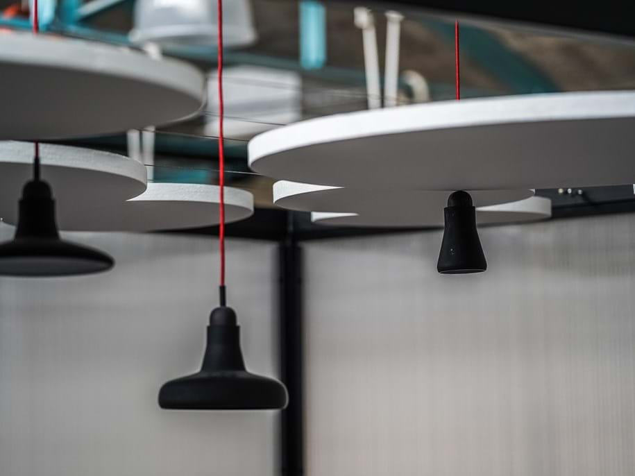 Close-up of free-hanging acoustic panels and lamps
