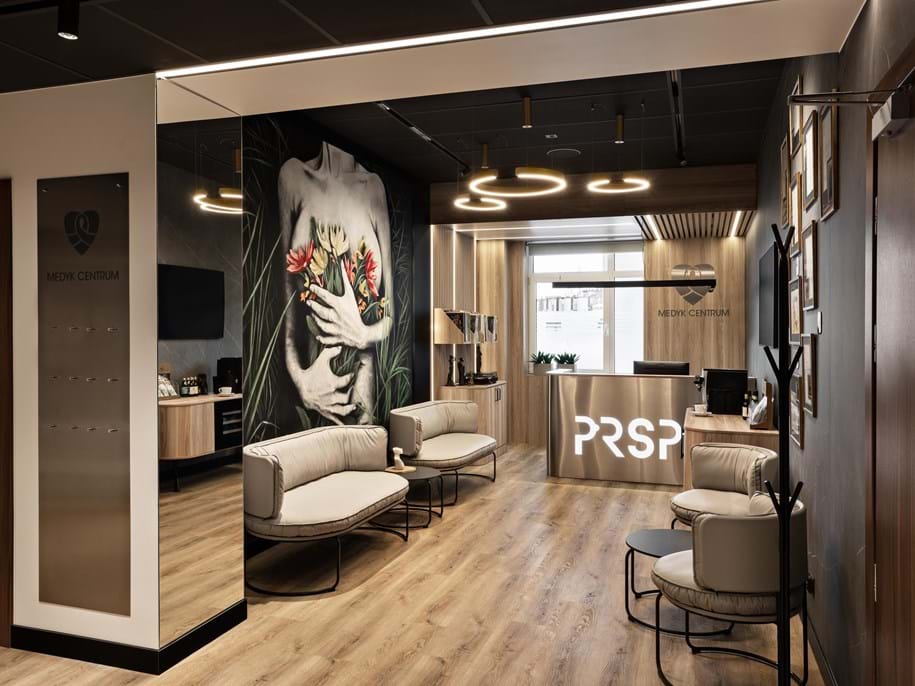Black, suspended acoustic ceiling in reception area of a plastic surgery clinic