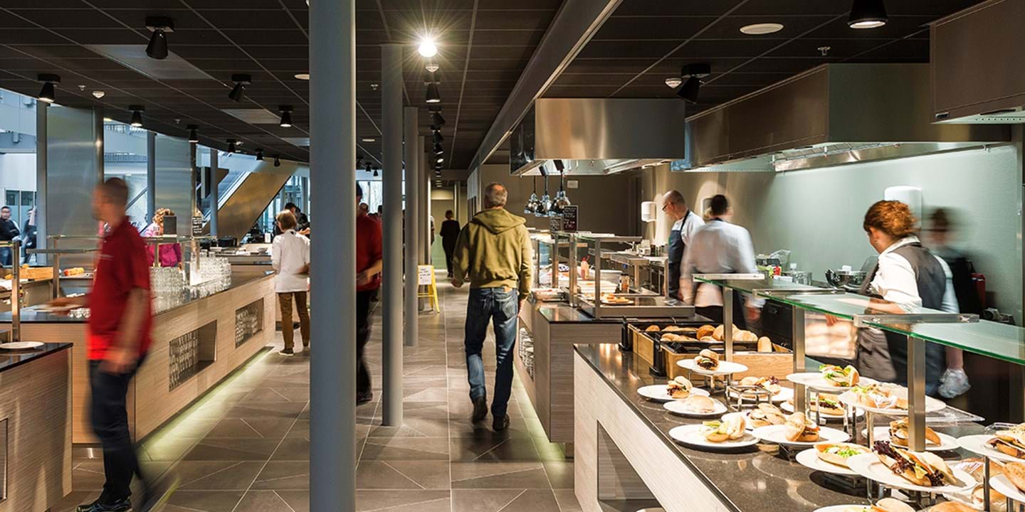 People taking food from a buffet