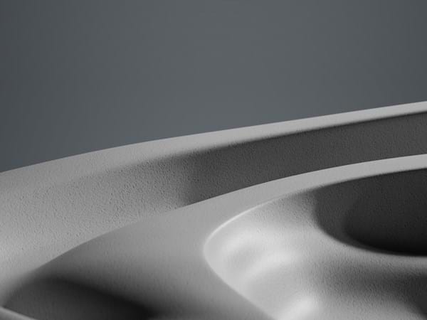 Close-up view of a smooth, curved surface with subtle gradients of light and shadow, creating an abstract monochromatic landscape.