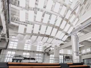 Sculptural ceiling installation with free-hanging acoustic panels in Techmania Science Center